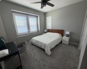 a bedroom with a bed and a ceiling fan at Bright and Cozy Bay Window Cottage 6 in Ontario