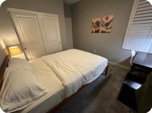 a bedroom with a white bed and a window at Bright and Cozy Bay Window Cottage 6 in Ontario +3 photos