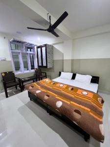 a large bed in a bedroom with a ceiling fan at Hotel Manimahesh Bharmour in Brāhmaur