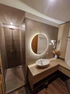 a bathroom with a sink and a mirror at Grande Vendégház in Tata +38 photos