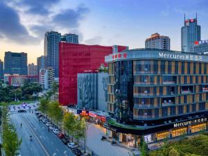 a city with a red building and a street with cars at Mercure Xi'an High-tech Zone Center in Xi'an