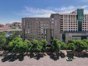 a large building with trees in front of it at Mercure Xian City Centre in Xi'an