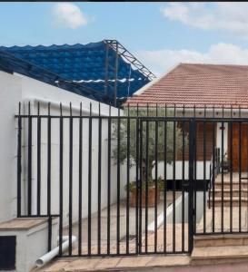 a gate in front of a house with a roof at Nova in Mendoza