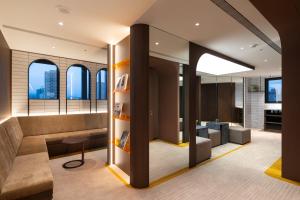 an office lobby with a view of the city at Boutech hotel Banqiao Yellowstone in Taipei