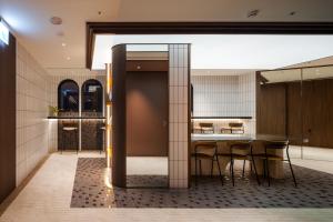 a dining room with a table and chairs at Boutech hotel Banqiao Yellowstone in Taipei