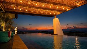 a swimming pool with lights on top of a building at The Kayangan Sanur in Sanur