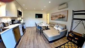a kitchen and living room with a table and a couch at Svitanok in Victoria