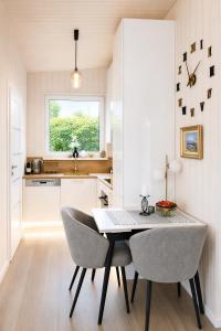 a kitchen with a table and chairs and a window at Aukštupio Vila in Aukštupėnai +17 photos