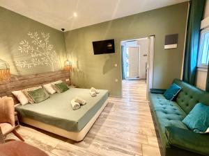 a bedroom with a bed and a couch at ΑVLI Sarti Studios & Apartments no1 in Sarti