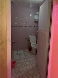 a small bathroom with a toilet in a room at منزل شامة in Moulay Yacoub