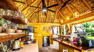 a large kitchen with a counter and a ceiling at Carpe Diem Casitas & Villas Mazunte in Mazunte