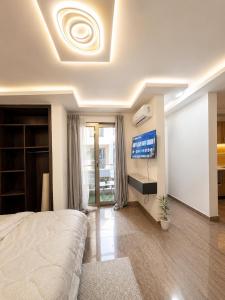 a bedroom with a bed and a flat screen tv at Suite BMB in Abidjan +6 photos