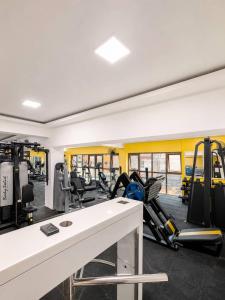 a gym with treadmills and machines in a room at Suite BMB in Abidjan