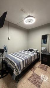 a bedroom with a bed and a camera in it at Hostal Arica 3 in Arica