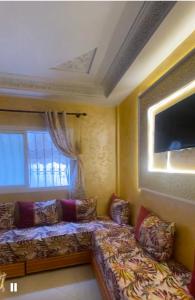 a living room with a couch and a window at منزل شامة in Moulay Yacoub