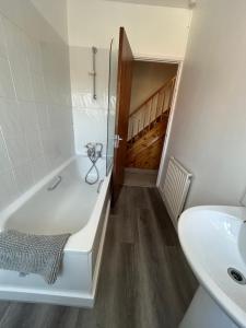 a bathroom with a bath tub and a sink at No 28B St Benedict in Glastonbury +13 photos