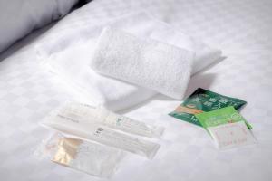 a pile of towels and other items on a bed at Ponpon Railway House in Kyoto