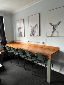 a conference room with a wooden table and chairs at Pint On Punt Backpackers in Melbourne