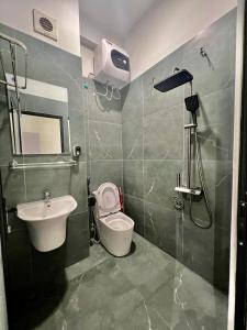 a bathroom with a sink and a toilet and a shower at Hanoi Backpacker Home in Hanoi