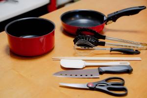 a table with two measuring cups and some kitchen utensils at Ponpon Railway House in Kyoto +129 photos