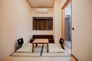 a small room with a table and chairs at Ponpon Railway House in Kyoto