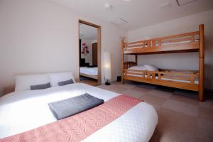 a bedroom with two beds and a bunk bed at Ponpon Railway House in Kyoto