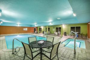 a pool room with a table and chairs next to a pool at Holiday Inn Express Hastings by IHG in Hastings
