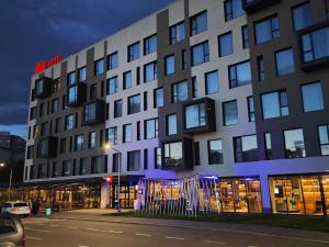 a building on a street in front of a building at ibis Timisoara City Center in Timişoara