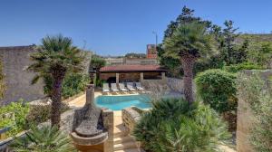 a house with a swimming pool and palm trees at Wonderful 4BR Farmhouse with Private Pool in Rabat +78 photos