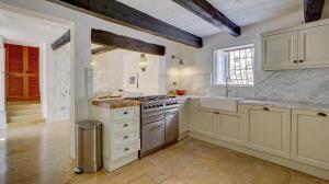a kitchen with white cabinets and a stove top oven at Wonderful 4BR Farmhouse with Private Pool in Rabat