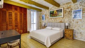 a bedroom with a bed and a desk in it at Wonderful 4BR Farmhouse with Private Pool in Rabat