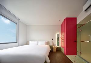 a bedroom with a large white bed and a red cabinet at Go Hotel Nakhon Sawan in Ban Pak Nam Pho +13 photos
