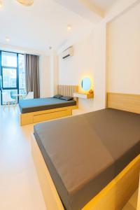 a bedroom with two beds and a living room at Hanoi Backpacker Home in Hanoi
