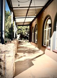 an empty hallway of a building next to a sidewalk at Makiti Retreat in Polokwane