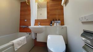 a bathroom with a toilet and a sink and a tub at Ueno Touganeya Hotel in Tokyo +16 photos