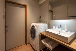 a bathroom with a washing machine and a sink at Hikoso-machi Kin no Ma in Kanazawa +29 photos