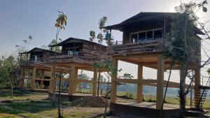 a house being constructed in the middle of a field at Bardiya Nature Lodge in Belā
