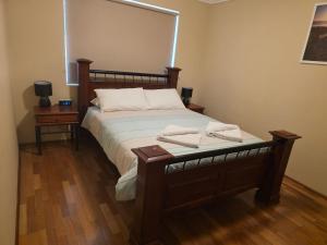 a bedroom with a bed with two towels on it at Getaway, Unit 20 Seafront Estate in Jurien Bay