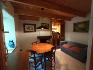 a living room with a table and a couch at Nice cottage in Brittany in Plouigneau