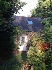 an old stone house with a window on it at Nice cottage in Brittany in Plouigneau