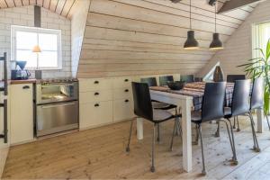 a kitchen with a table and chairs in a room at The Aspö Hideaway in Drottningskär