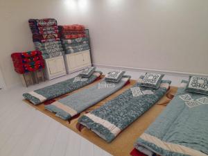 a room with four pillows on the floor with at Guest House Maral in Bokonbayevo