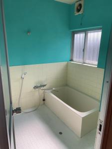 a bathroom with a bath tub and a window at Stonehouse2 in Usa