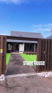 a home with a fence and a stone house at Stonehouse2 in Usa
