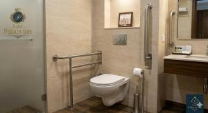 a bathroom with a toilet and a sink at Hotel Palace inn Agra in Tājganj +15 photos