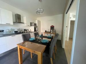 a kitchen and dining room with a table and chairs at Casa Valeria in Abano Terme