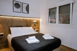 a bedroom with a bed with two towels on it at FOS Kastoria in Kastoria