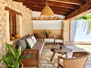 an outdoor patio with a couch and a table at Villa Can Tonet in Port de Pollensa