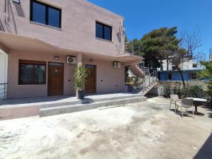 a house with a potted plant in front of it at Vila Martini in Vlorë