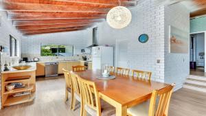 a kitchen and dining room with a wooden table and chairs at The Cove in Scotts Head